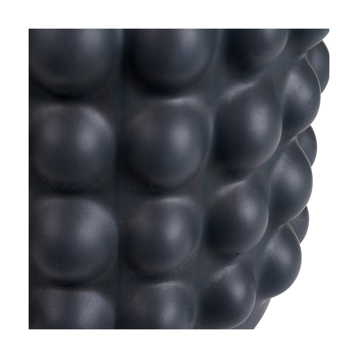 Close-up of the Sohan Black Bobbled Ceramic Tall Table Lamp Base, showing a matte black textured surface with a raised bubble pattern.