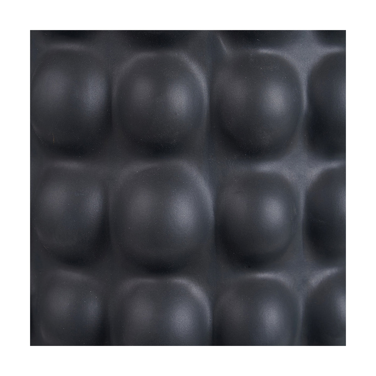 Close-up of the Sohan Black Bobbled Ceramic Tall Table Lamp Base, 48cm, showing its textured, rounded bobble pattern in a matte black ceramic finish.