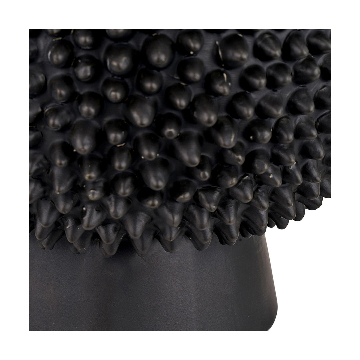 Close-up of the Wrenley Black Ceramic Sea Urchin Table Lamp Base, 37cm, showing textured spiky black ceramic detail above a smooth tapered base.
