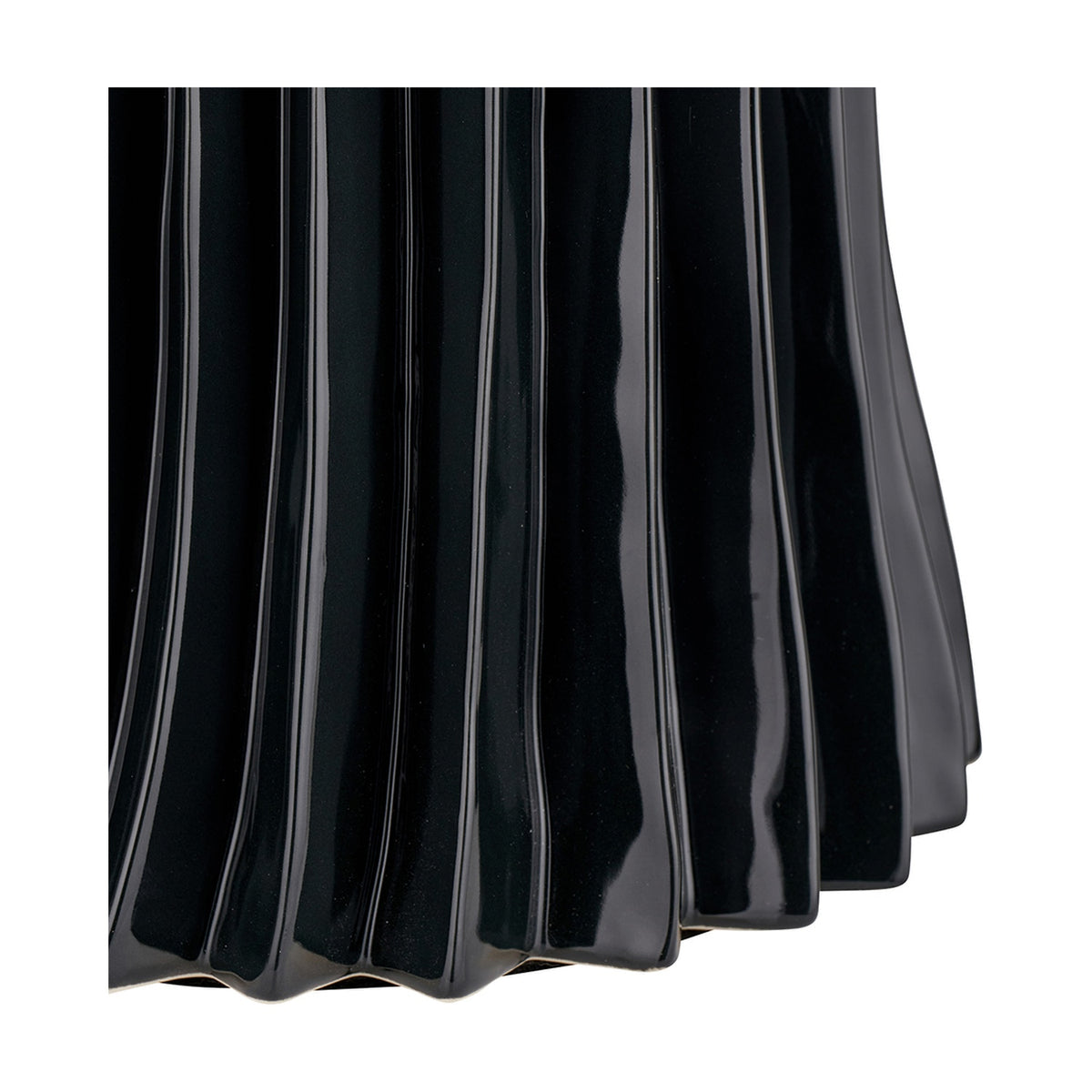 Close-up of the Devony Black Pleated Ceramic Table Lamp Base, showing ridged, wave-like fluted texture in a glossy black ceramic finish against a white background.