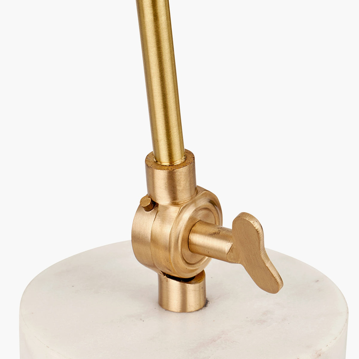 Close-up of the Eloise Gold Brass & Marble Table Lamp showing a brushed brass rod, adjustable knob switch, and round white marble base.