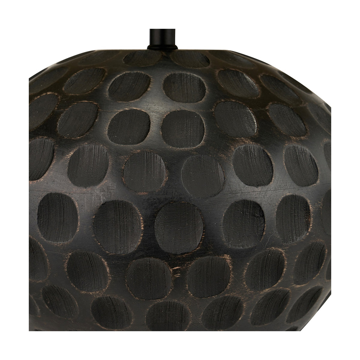 Close-up of the Dante Antique Black Mango Table Lamp base, showing carved mango wood with a dotted, honeycomb-style texture in an antique black finish.