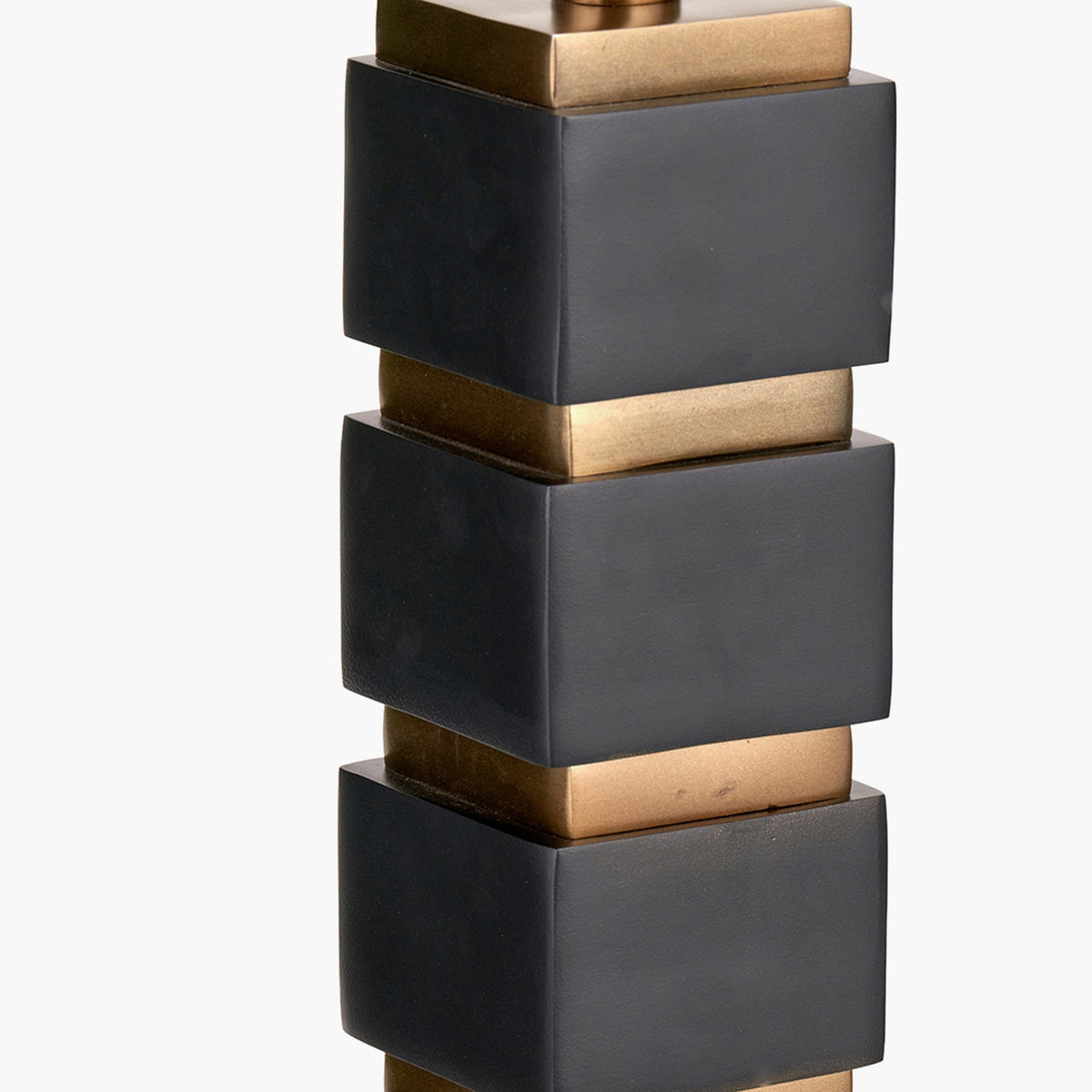 Maximo table lamp base, 49cm, with stacked matt black cube sections separated by antique brass square connectors, shown in close-up on a plain white background.