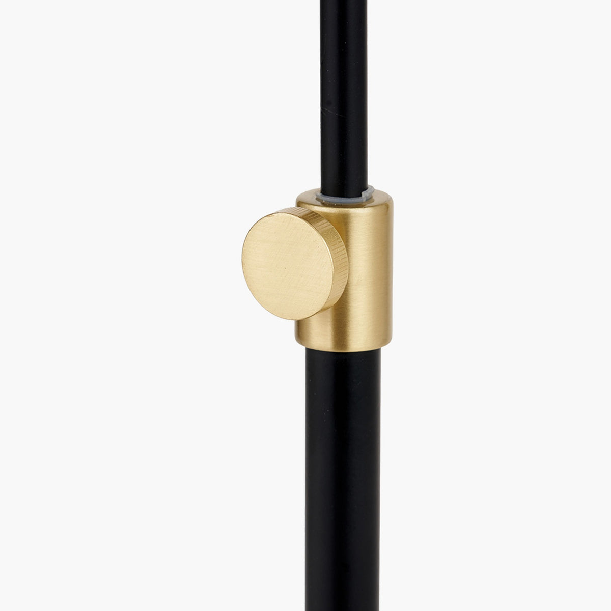 Close-up of the Bryce Black & Gold Iron Rise & Fall Table Lamp showing the round brushed gold height-adjustment knob on the black iron pole, set against a plain white background.