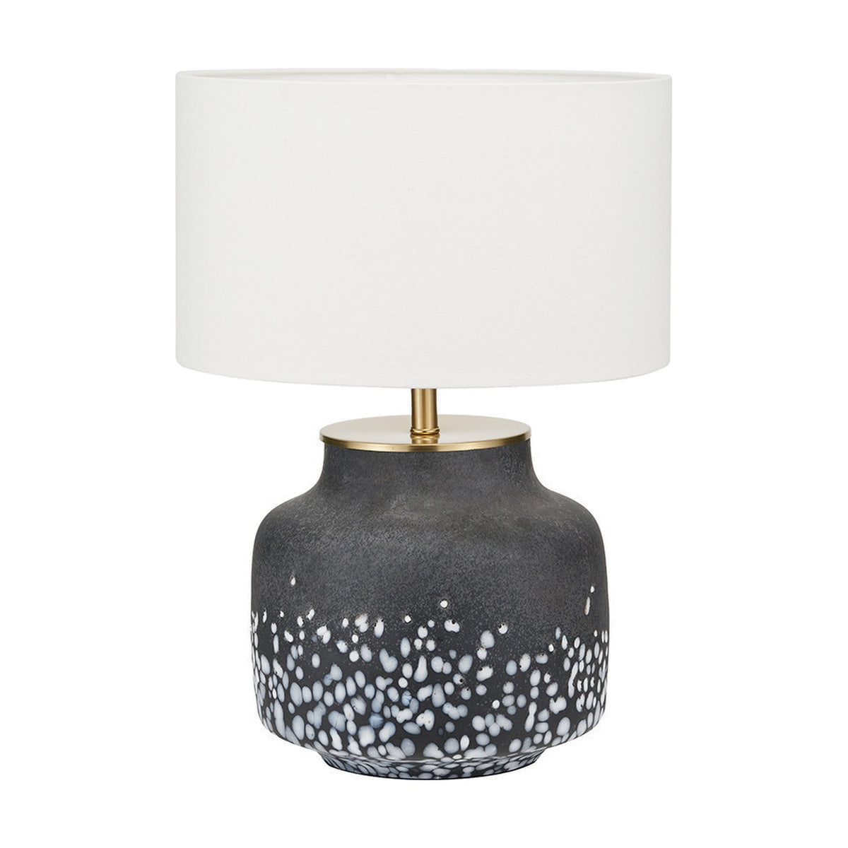 Etna Black & White Glass Table Lamp Base, 33cm, with speckled black and white ceramic-look body, brass neck fitting, and white drum shade on a plain background.