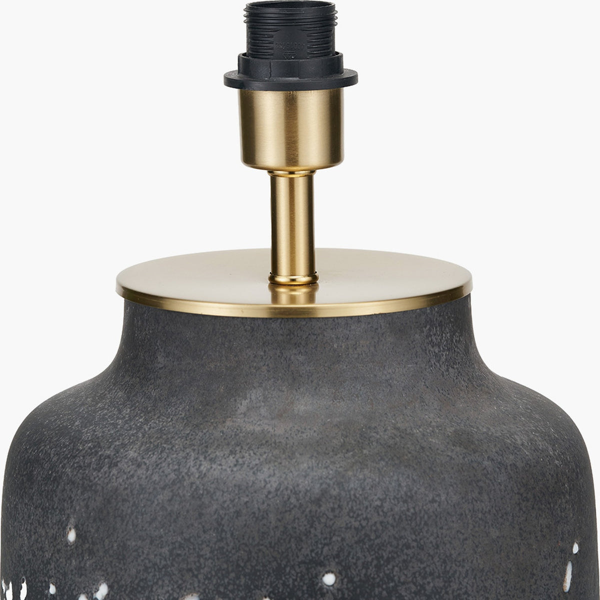 Close-up of the Etna table lamp base's brass fitting and neck above a mottled black glass body with a brushed brass cap, on a plain white background.