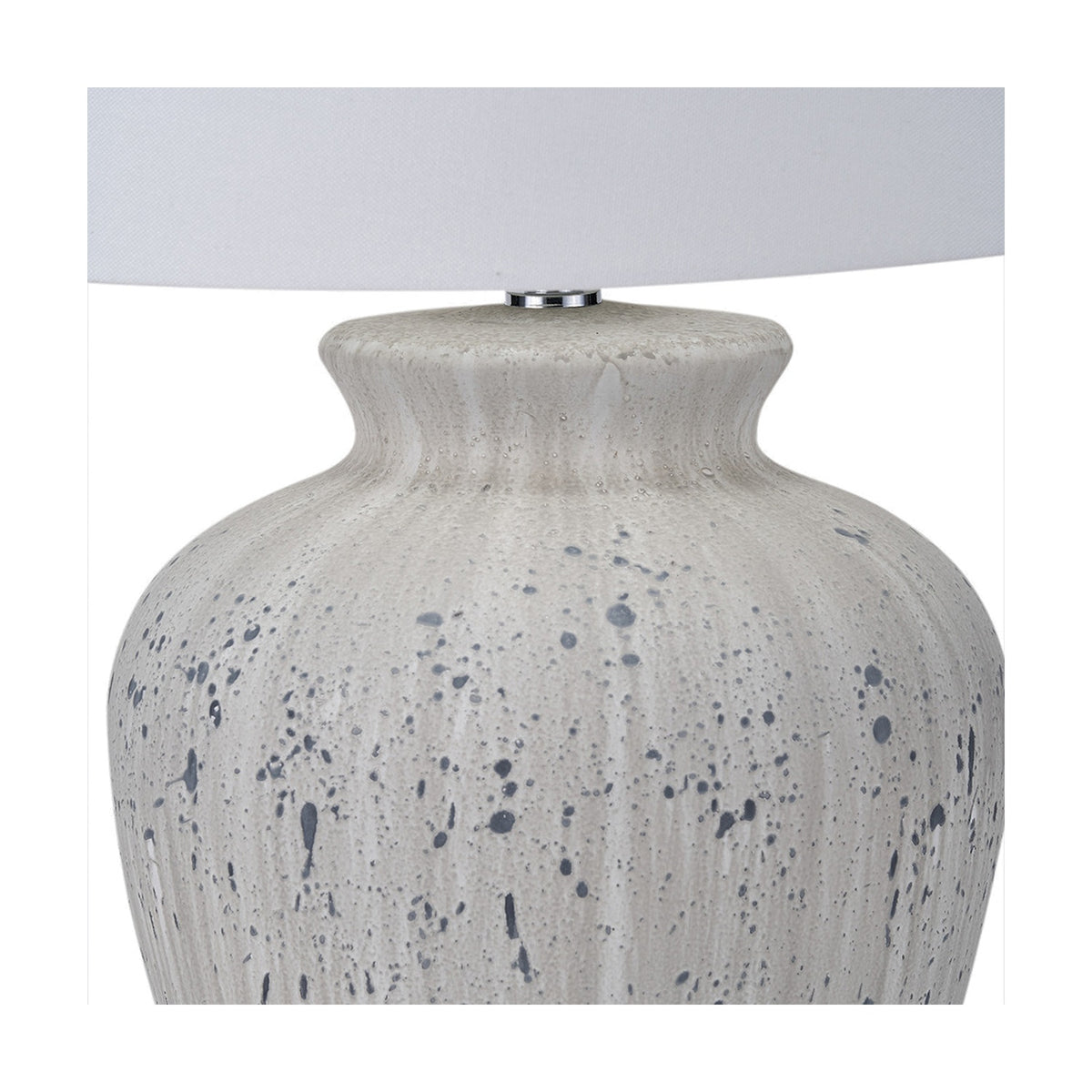 Close-up of the Kalli White & Grey Flecked Ceramic Table Lamp, showing the textured splatter-glazed base and neck beneath a white fabric shade, on a plain background.