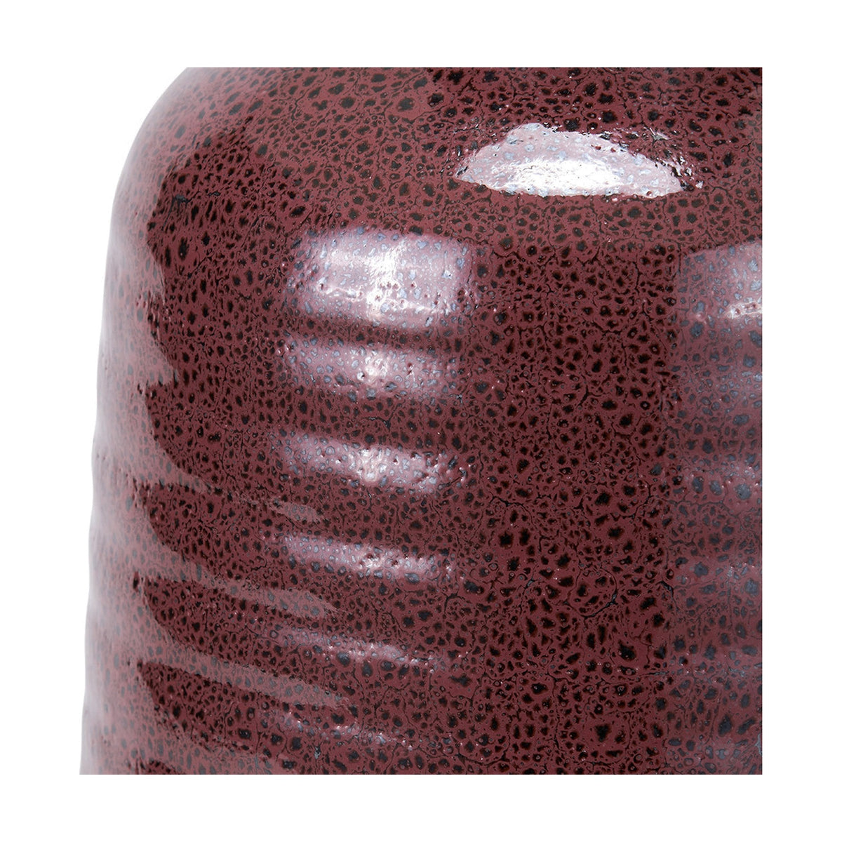 Close-up of the Helka Mulberry Red Reactive Glaze Table Lamp base, showing textured ceramic surface with a speckled glaze and ribbed detailing in deep mulberry red.