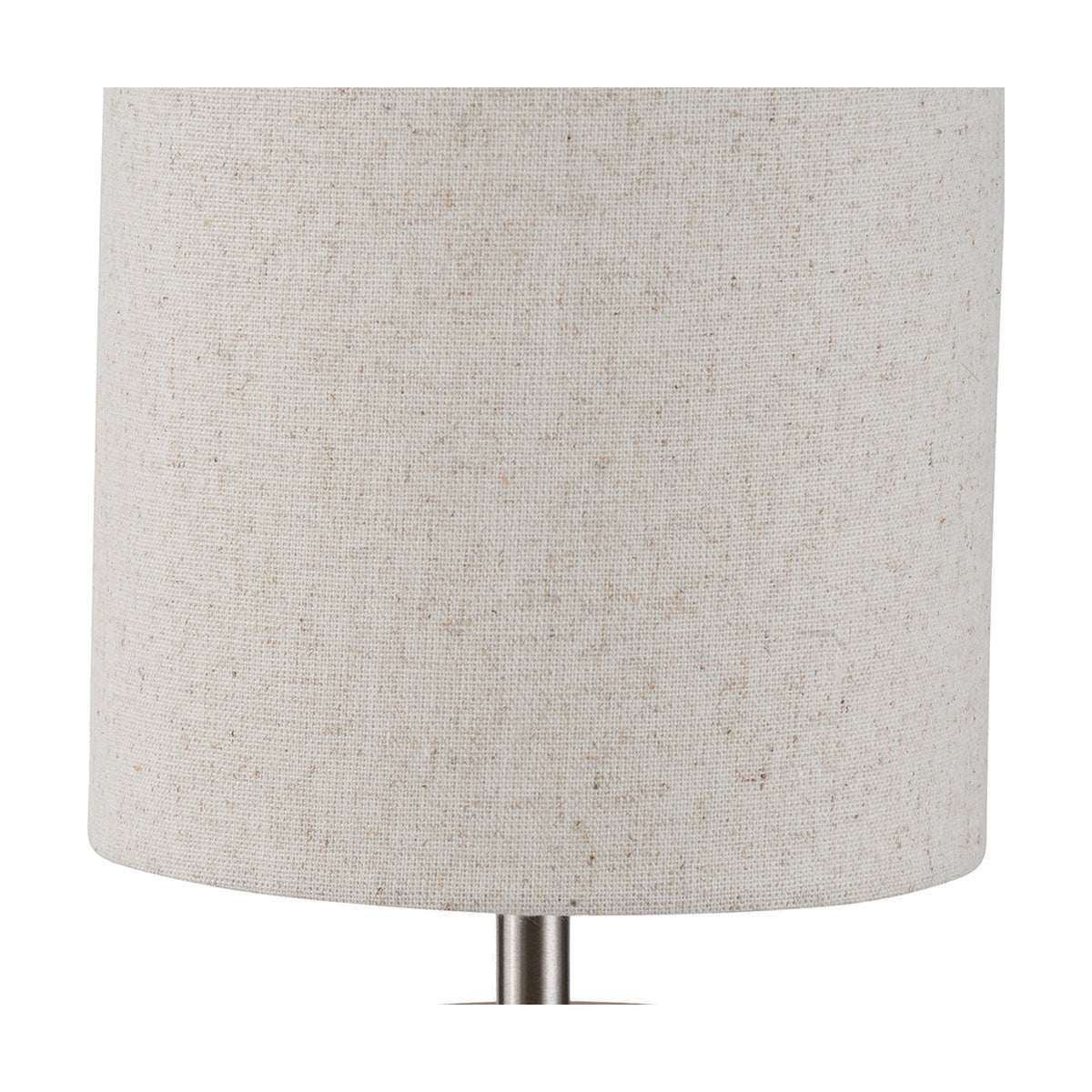 Close-up of the Bonham Table Lamp's linen drum shade in natural beige, showing a silver metal stem below, on a plain white background.