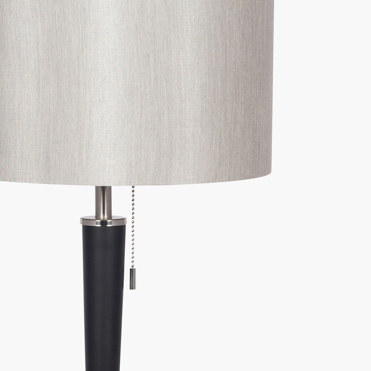 Close-up of the Lowry Table Lamp's neck, showing a brushed silver joint, pull-chain switch, and matt black tapered iron stem beneath a light grey fabric shade.