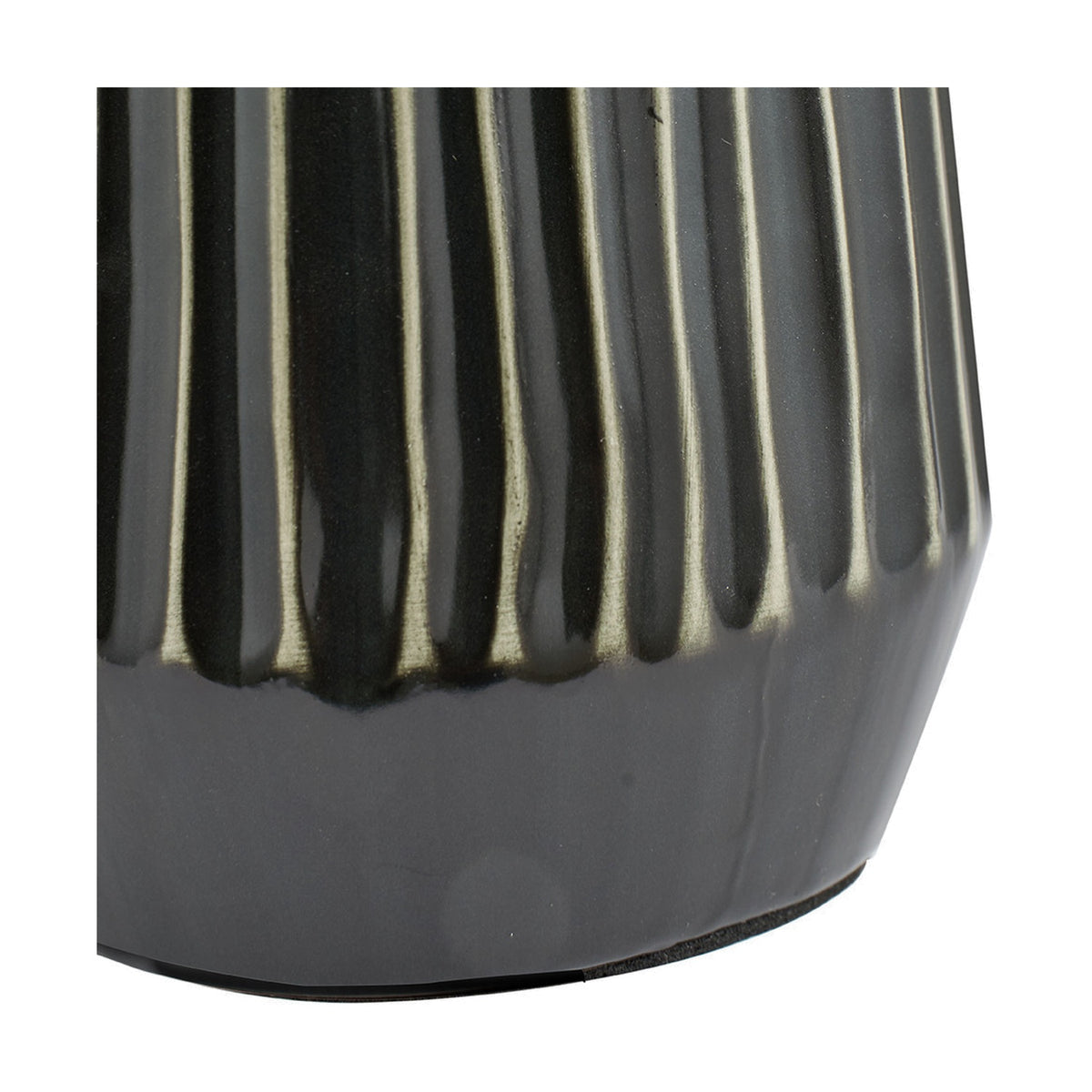 Close-up of the Artemis table lamp's black textured ceramic base, showing vertical ribbed detailing with silver-toned highlights along the ridges.