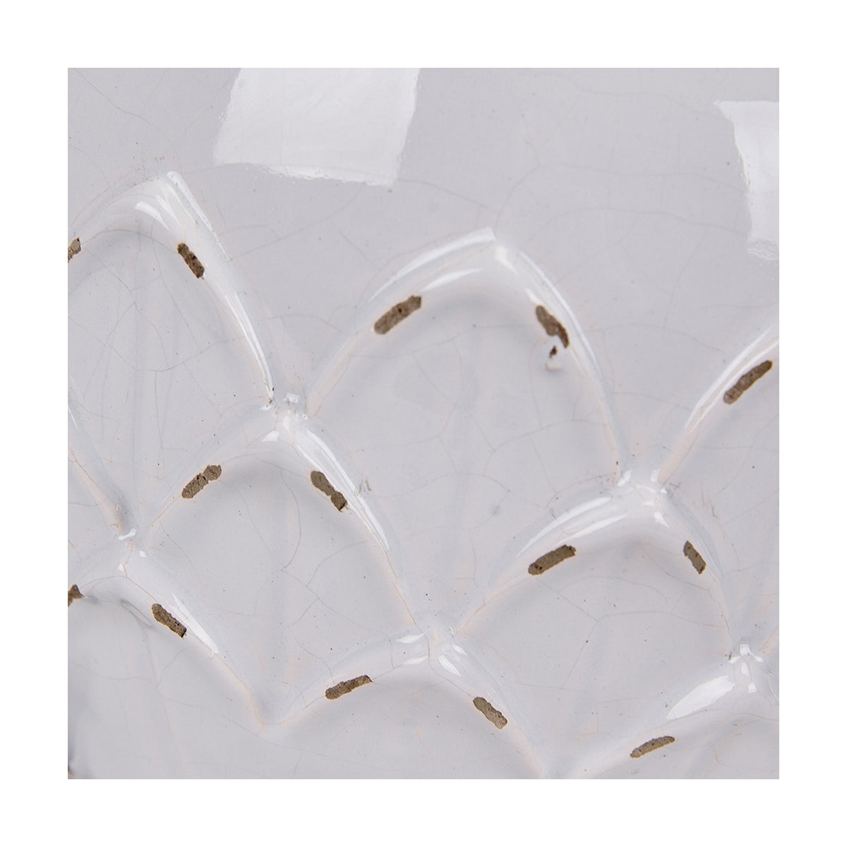 Close-up of the Willow White Leaf Detail Small Stoneware Table Lamp Base, showing white ceramic with a raised scalloped leaf pattern and gold-flecked texture.