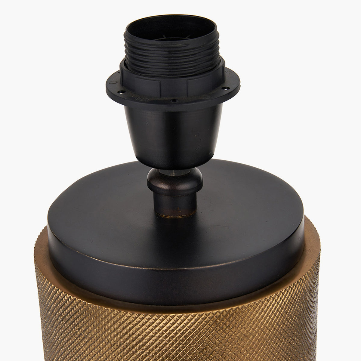 Close-up of the Aurelio Black Textured Table Lamp Base, showing a black E27 bulb holder atop a matte black disc, set on a knurled brass cylindrical base, on a plain white background.