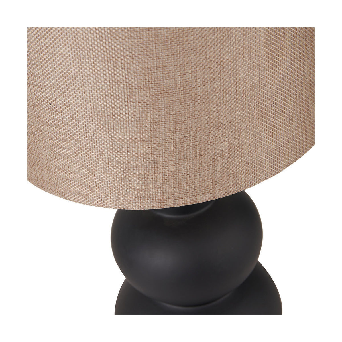 Close-up of the Aaliyah Black Curved Bottle Ceramic Table Lamp base, showing its rounded matte black ceramic form beneath a woven beige linen drum shade.