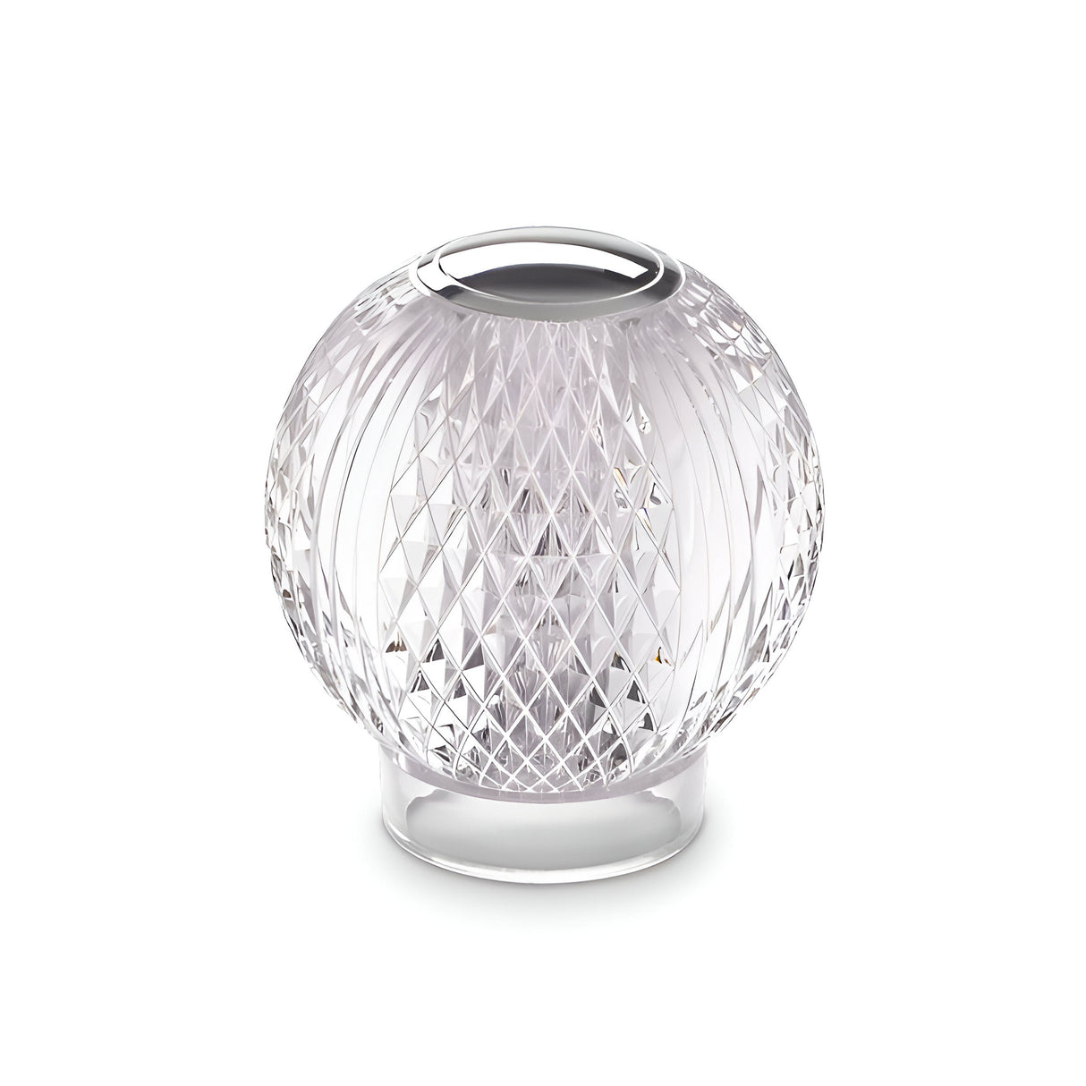 A clear, spherical glass base of the Lustris LED Table Lamp 2.2W 3000K sits on a plain background, featuring a textured, diamond-cut design. The intricate pattern creates a prism effect, reflecting light as uniquely as a crystal diffuser.