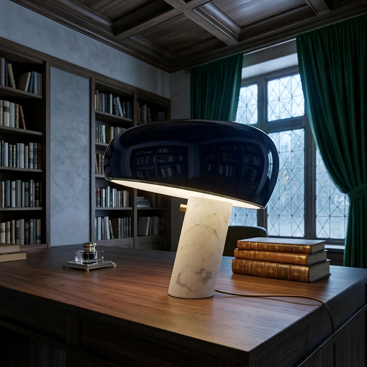 Niori Sleepy Marble Table Lamp with glossy black domed shade and white marble base on a wooden desk beside leather books in a library setting.