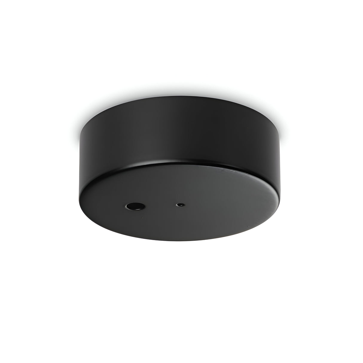 The Glacia 1 Light Magnetic Ceiling Rose - Black is a stylish ceiling-mounted sensor with a sleek, minimalist design. It boasts two small openings on its surface for detection or signaling, set against a plain white background, enhancing its modern lighting aesthetic.