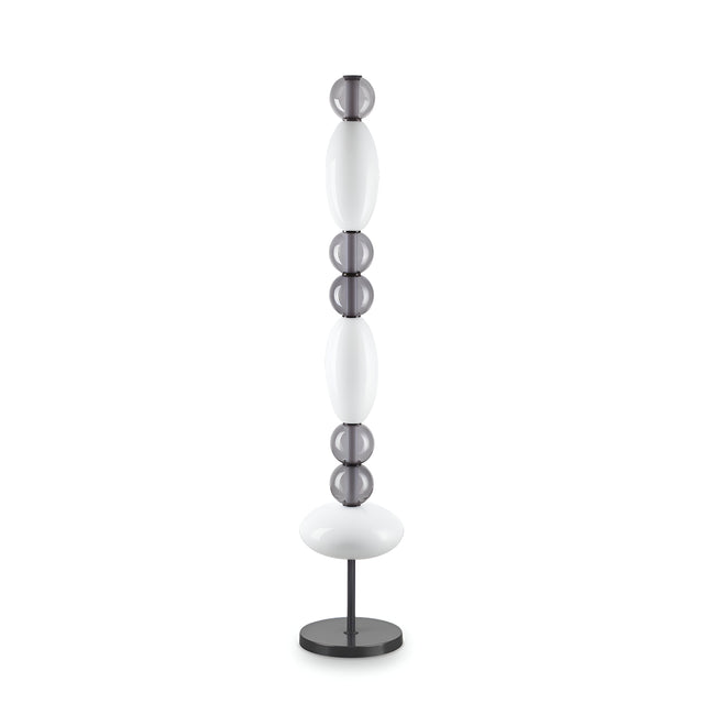 Introducing the Gleara LED Floor Lamp, featuring a sleek contemporary design with alternating white and translucent round and oval segments resting on a black circular base, offering energy-efficient illumination.