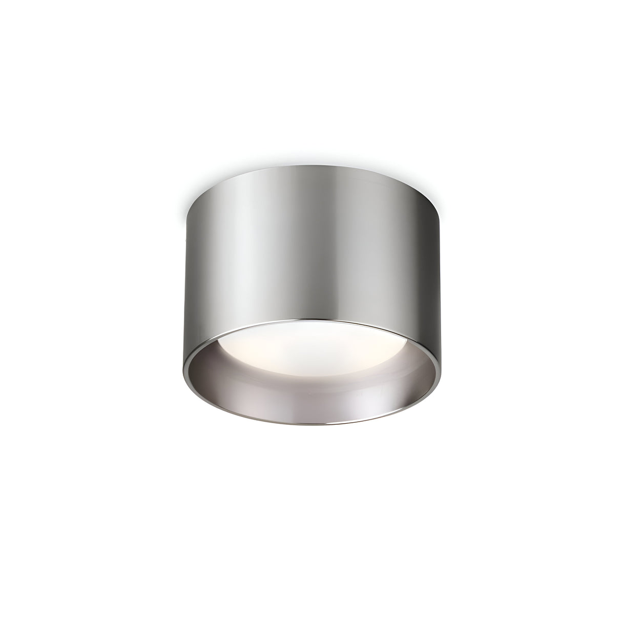 The Orbis Round Downlight - Nickel is a contemporary, cylindrical silver ceiling light fixture with a sleek nickel finish. It features a smooth surface and a round downlight opening, mounted on a white ceiling against a simple backdrop, and comes equipped with an energy-efficient, replaceable LED.