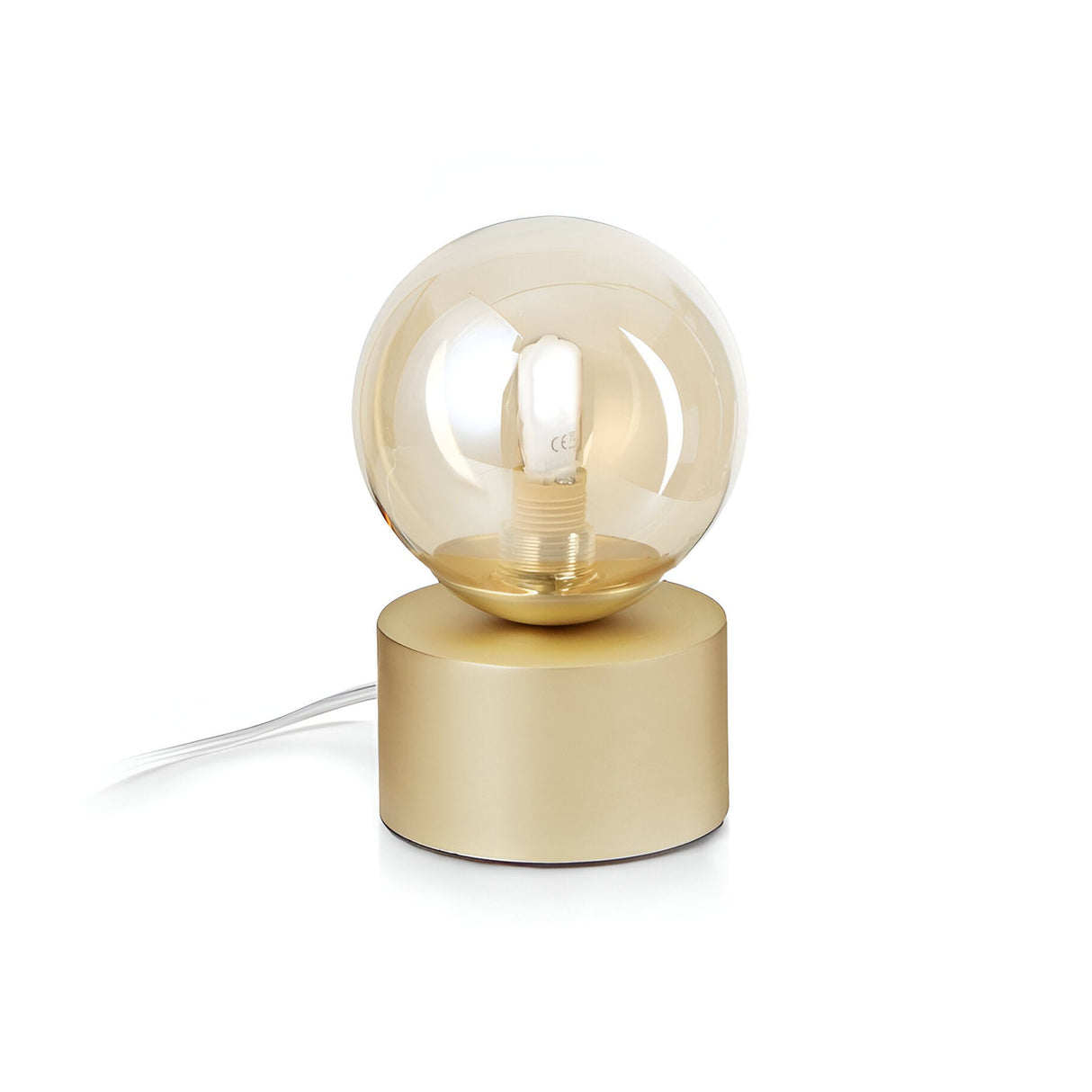 Introducing the Solana Small Table Lamp - Brass, showcasing a minimalist design with a round, clear glass bulb set on a brass frame. Its cylindrical metallic gold base perfectly complements the visible filament and white power cord, while an acid-etched white glass diffuser adds a sophisticated touch to its modern aesthetic.