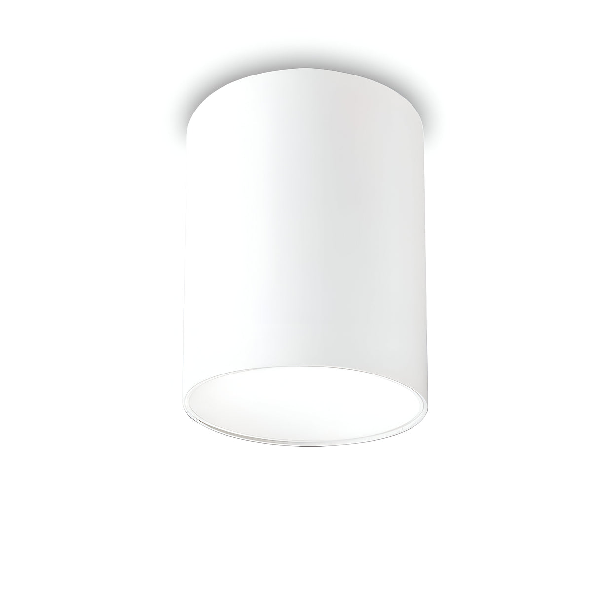 A Lucent LED Round Downlight 25W 3000K - White, 10cm is mounted on a white ceiling, seamlessly blending into its minimalist design. This modern fixture, renowned for its energy efficiency, boasts a smooth surface without visible patterns and softly emits light from the open bottom of the cylinder.