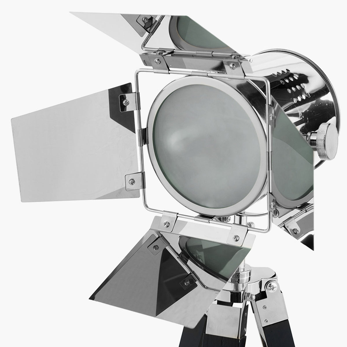 Close-up of the Hereford Silver & Black Tripod Floor Lamp head, showing a chrome barn-door style spotlight with hinged metal flaps and round glass lens, set against a plain white background.