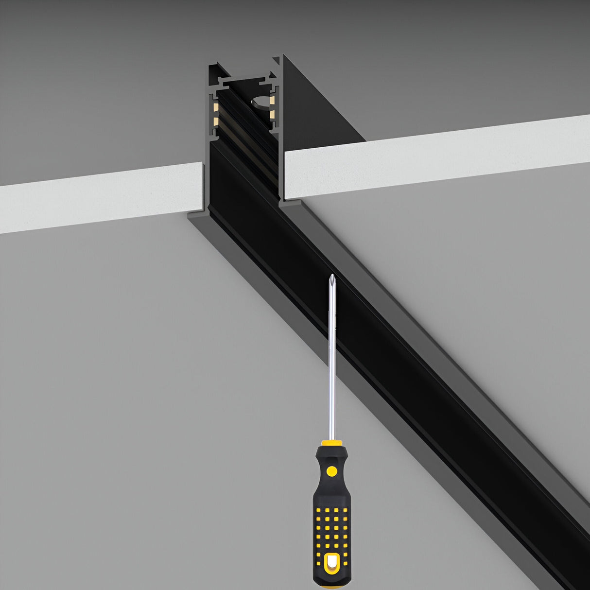 A Luxeon Slim Recessed Magnetic Track 2m in black is positioned into a design groove on a gray surface, connecting to a white panel and demonstrating an assembly or installation process.