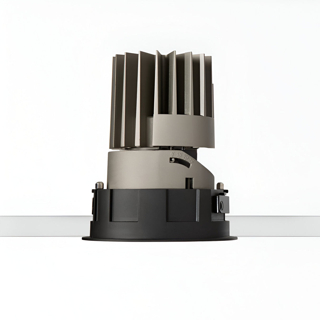 Featuring a Glistenis Trim Round Frame 109mm in black, this cylindrical metallic object with vertical fins is set against a white background and resembles a modern industrial light fixture or component. Its sleek black finish base boasts adjustable settings, making it ideal for downlight installations, while adding contemporary elegance.