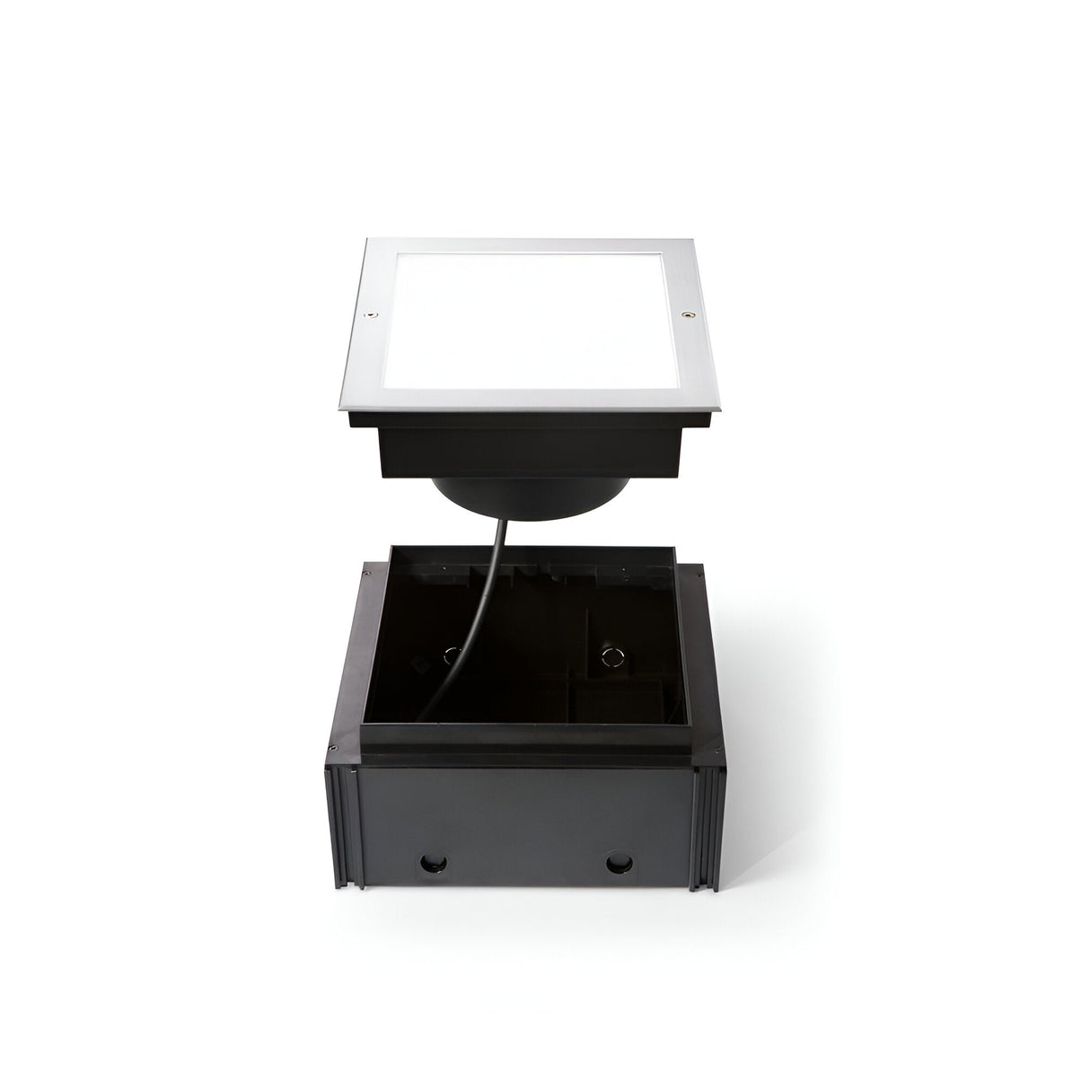 Introducing the Zephyra LED Square Recessed Ground Light - 16W, 3000K in Silver. This robust fixture is designed to blend seamlessly into outdoor surfaces, showcasing an open square frame and visible wiring. Its durable steel housing ensures longevity and a dependable cable guarantees secure electrical connection, making it perfect for outdoor illumination needs.