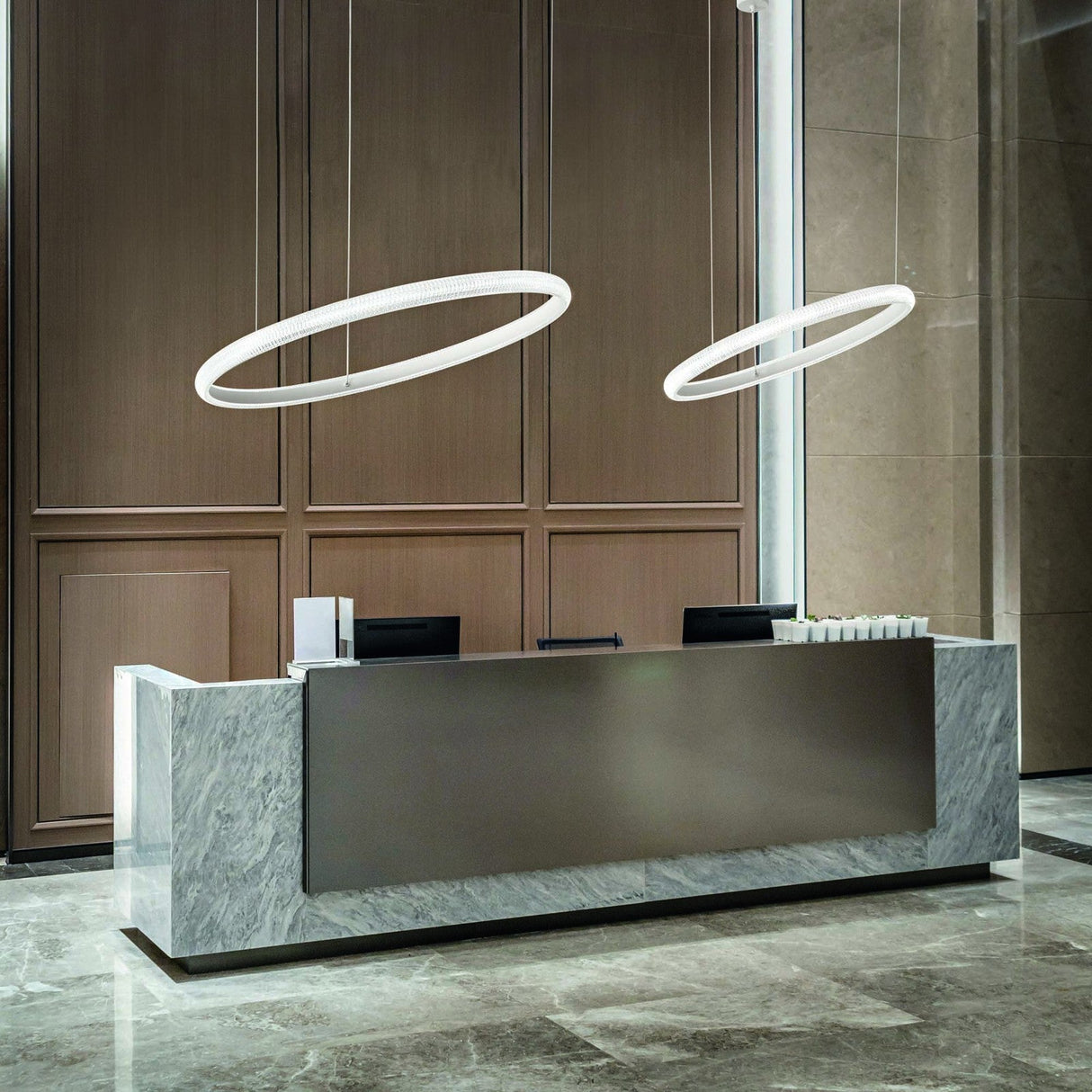 Miracle ring pendant lights above a reception desk