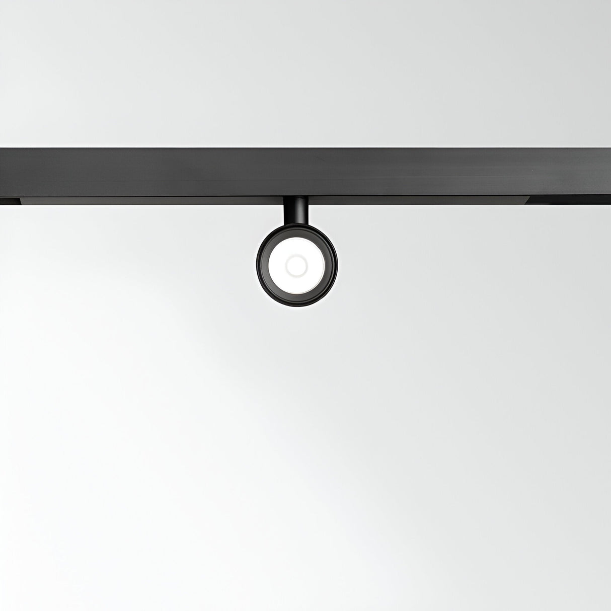 The image showcases a minimalist design with the Viora Magnetic Dimmable LED Track Spotlight 3W 3000K in black, elegantly suspended from a black track against a plain white background. This modern fixture combines energy-efficient lighting with simple yet stylish aesthetics.