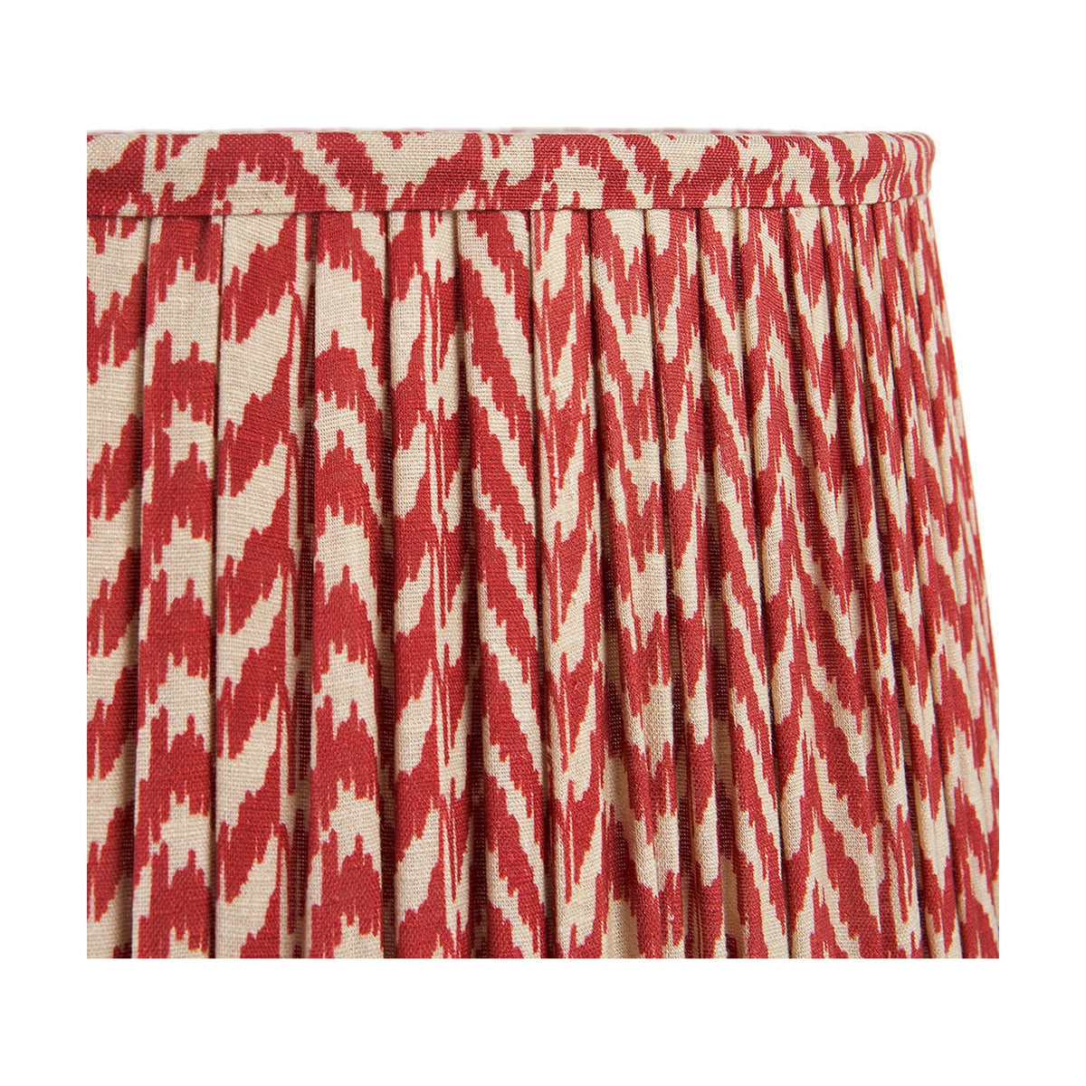 Close-up of the Vienna Red Chevron Pleated Lampshade, 50cm, showing red and cream zigzag fabric with pleated sides and a top trim edge, on a plain background.