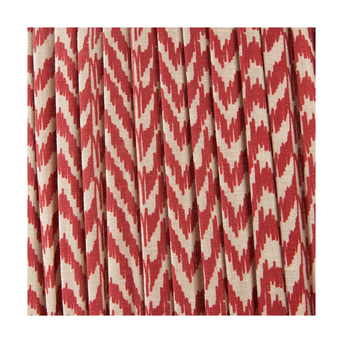 Close-up of the Vienna Red Chevron Pleated Lampshade, 50cm, in fabric with a red and cream zigzag pattern showing pleated vertical folds.