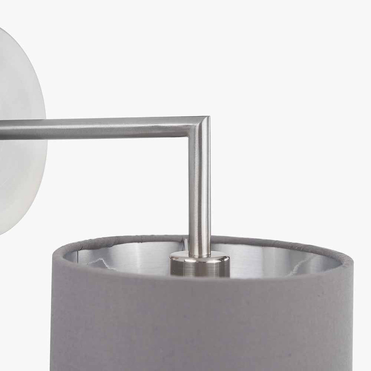 Close-up of the Elin wall light's brushed silver arm and steel grey fabric shade, showing the angular metal joint and mounting detail on a white background.
