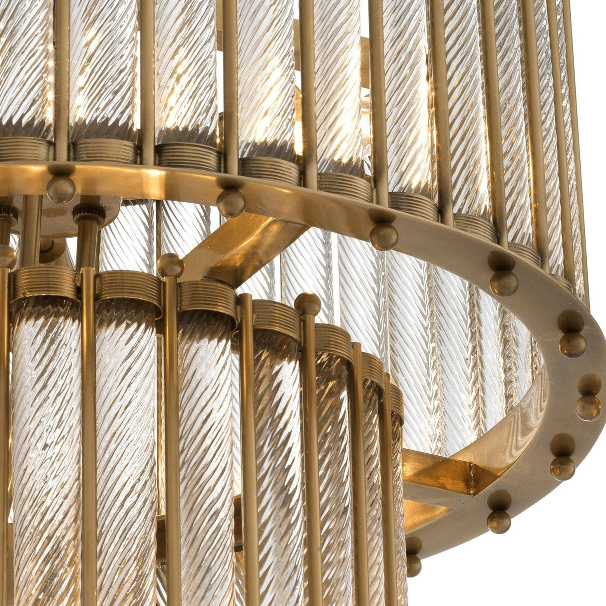 Close-up of the Helixora 10 Light Layered Twist Chandelier in Brushed Bronze, showcasing sculptural vertical ribbed glass rods and gold rings with decorative round studs for a luxurious modern look.
