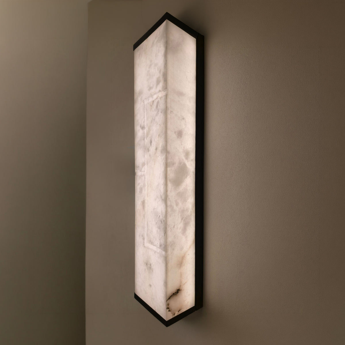 Eryndor LED Alabaster Wall Light in matt black and soft white, tall rectangular alabaster panel with black metal edges, illuminated on a neutral wall.