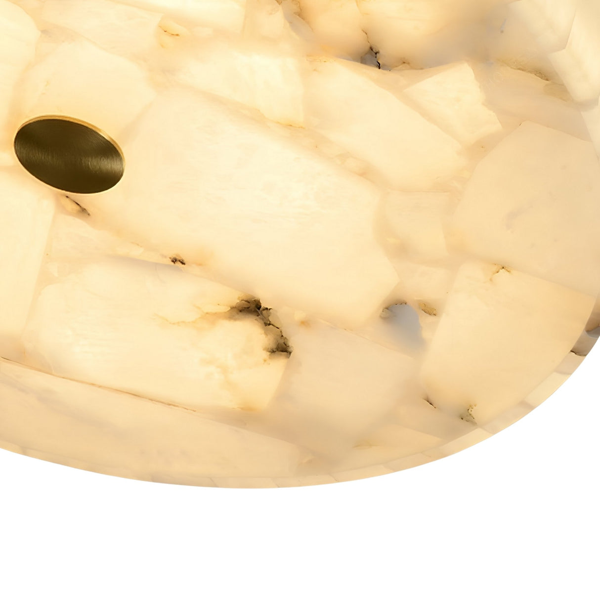Close-up of the Veltrix LED Medium Round Alabaster Flush Ceiling Light in soft white, featuring translucent cream-hued stone with subtle veining and a small brushed brass accent near the edge.