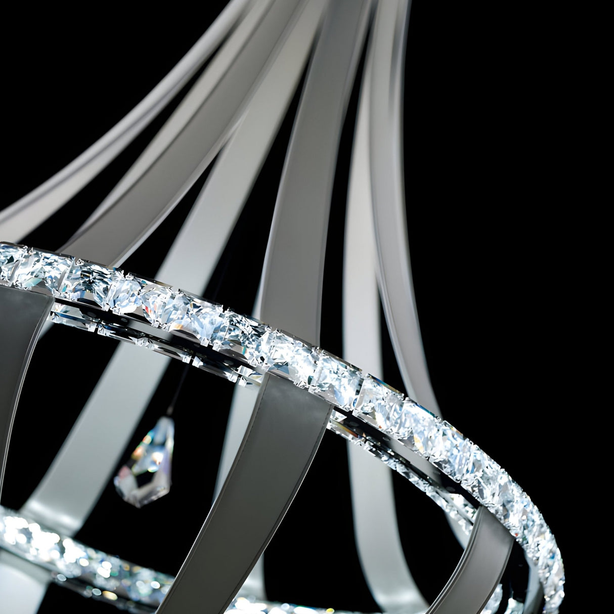 Close-up of the Tessaro LED K9 Crystal & Leather Small Chandelier in Black, featuring a circular frame with sleek metal arms and sparkling K9 crystals, including a central crystal pendant, set against a black background.