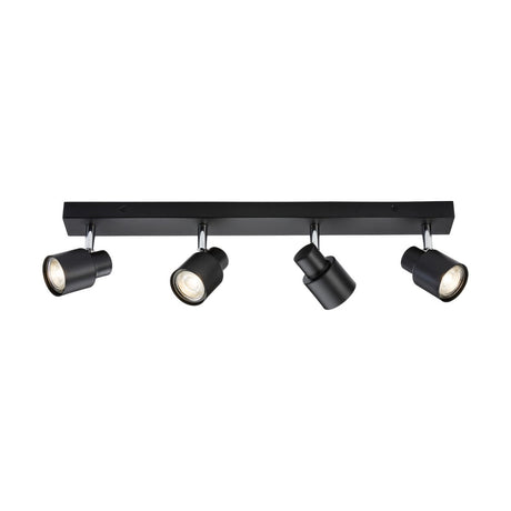 The Quad Bar Spotlight - Matt Black is a contemporary ceiling track light fixture equipped with four adjustable directional heads. Mounted on a sleek rectangular bar, each head faces different directions. This minimalist design incorporates GU10 spotlights for versatile illumination.