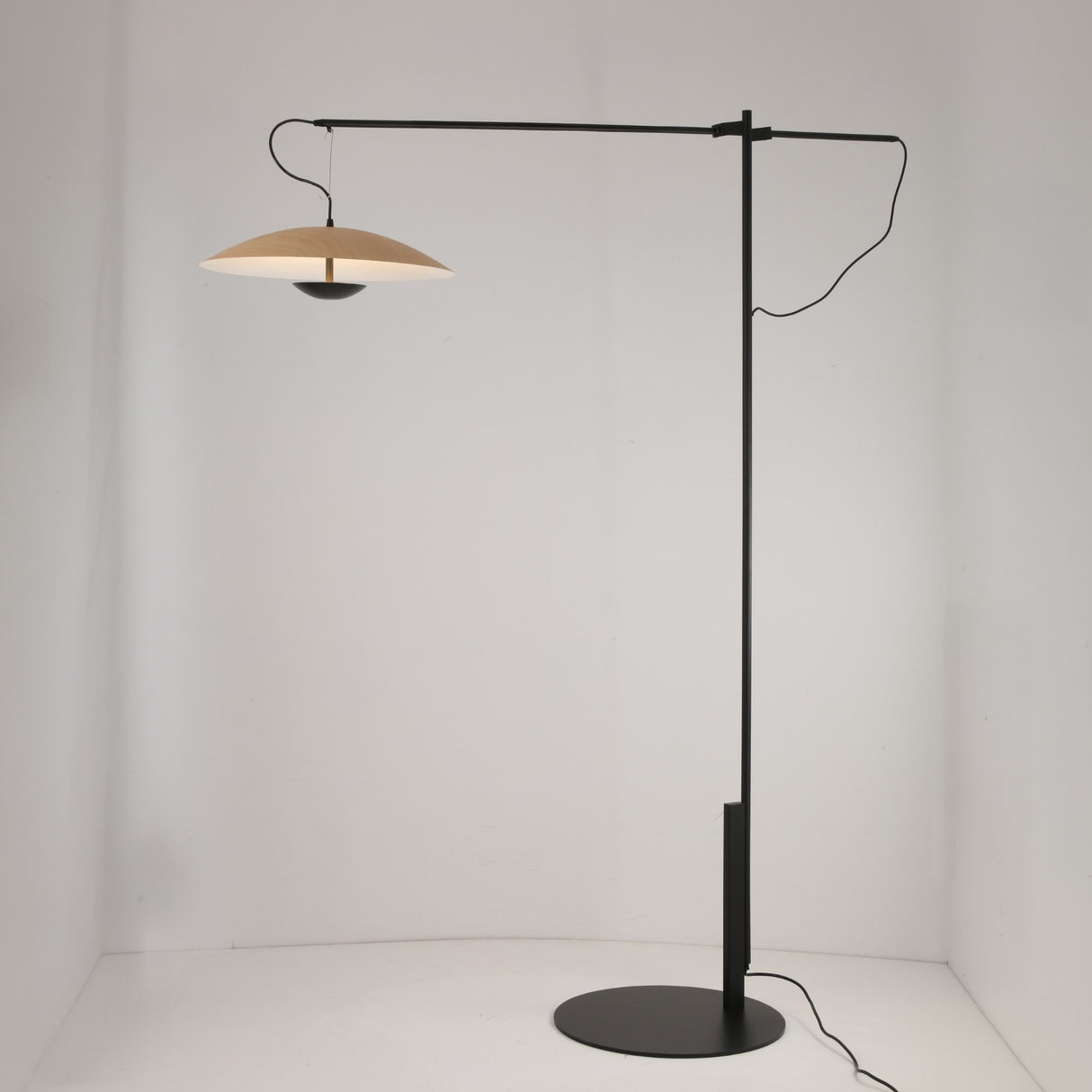 The Ginger LED Large Floor Lamp – Black & Brown features a modern black metal frame with a horizontal arm and wide brown disc-shaped shade, showcasing minimalist design in a plain white space.