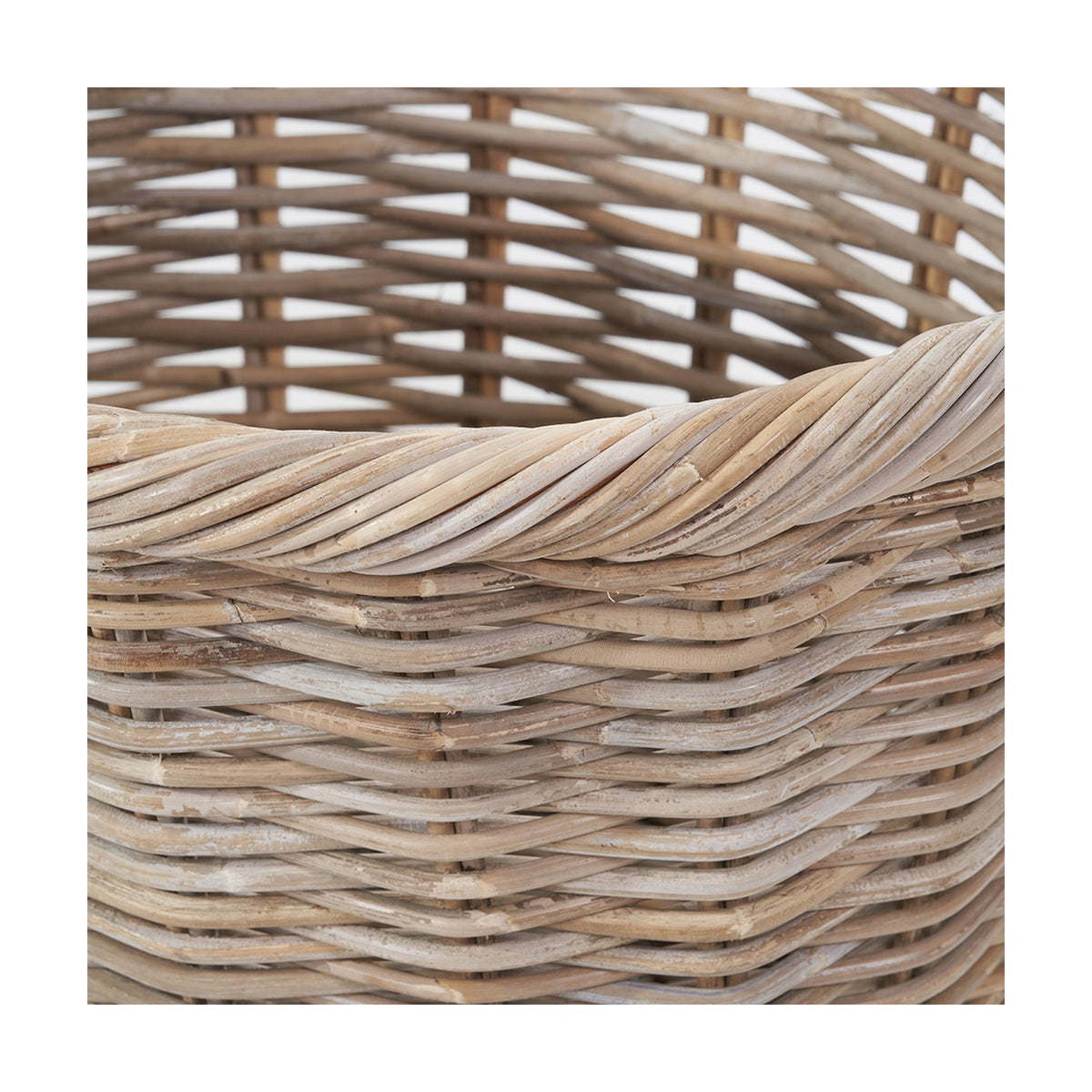 Close-up of a grey Kubu rattan oval shopping basket, showing woven diagonal rim detail and textured basketweave sides against a white background.