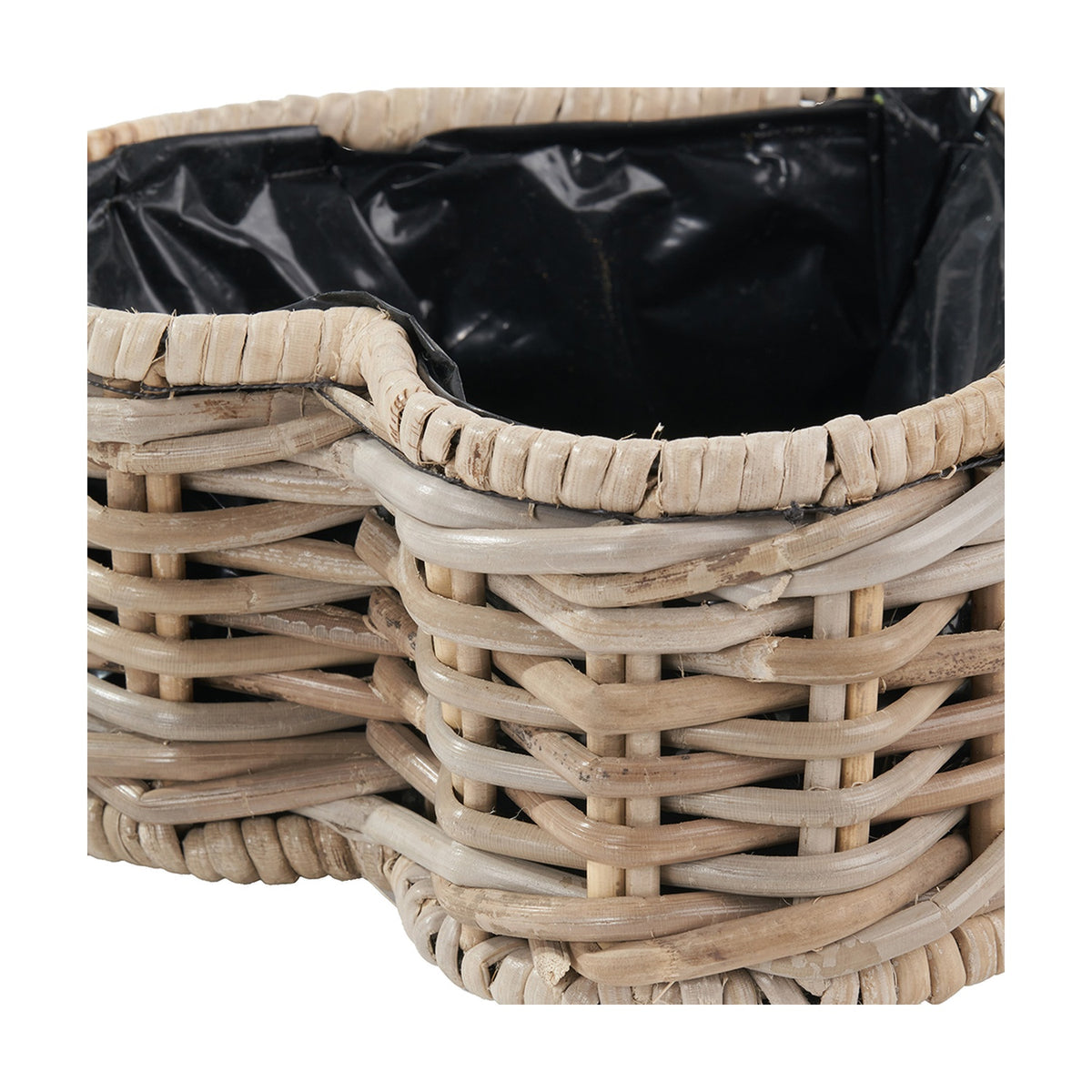 Close-up of the Tobs grey Kubu rattan heart-shaped basket planter, showing woven rattan sides and a black plastic liner visible at the rim.
