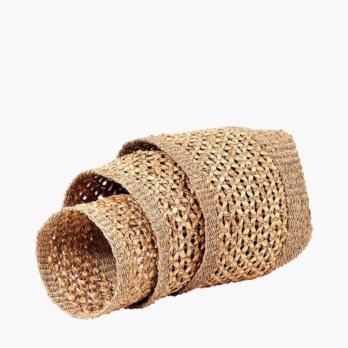Set of 3 nested tall storage baskets in natural seagrass and water hyacinth with an open woven texture, graduated sizes stacked at an angle on a plain white background.