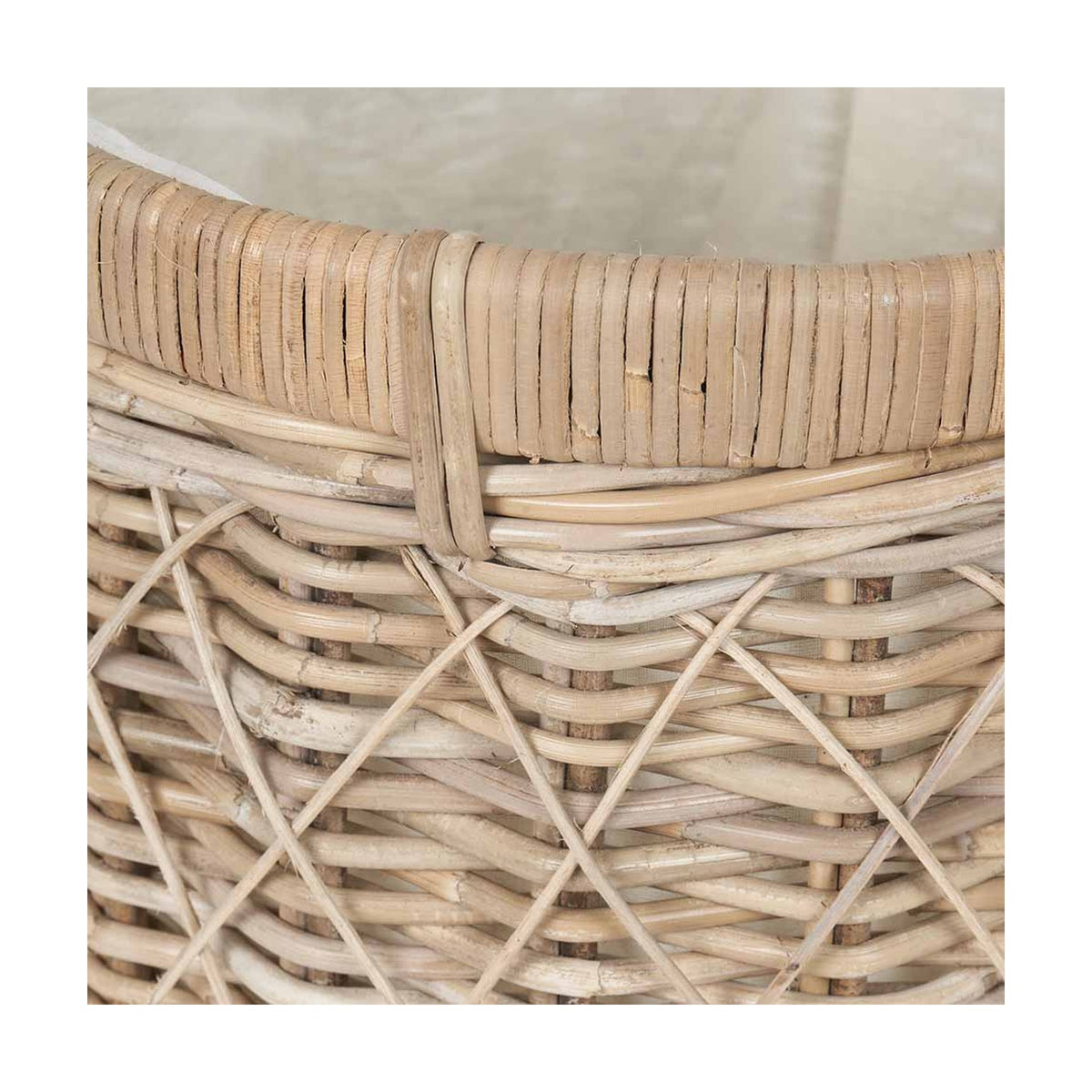 Close-up of the Brown Rattan Linen Basket, 42cm, showing woven rattan sides and a wrapped rim edge with visible cane binding detail.