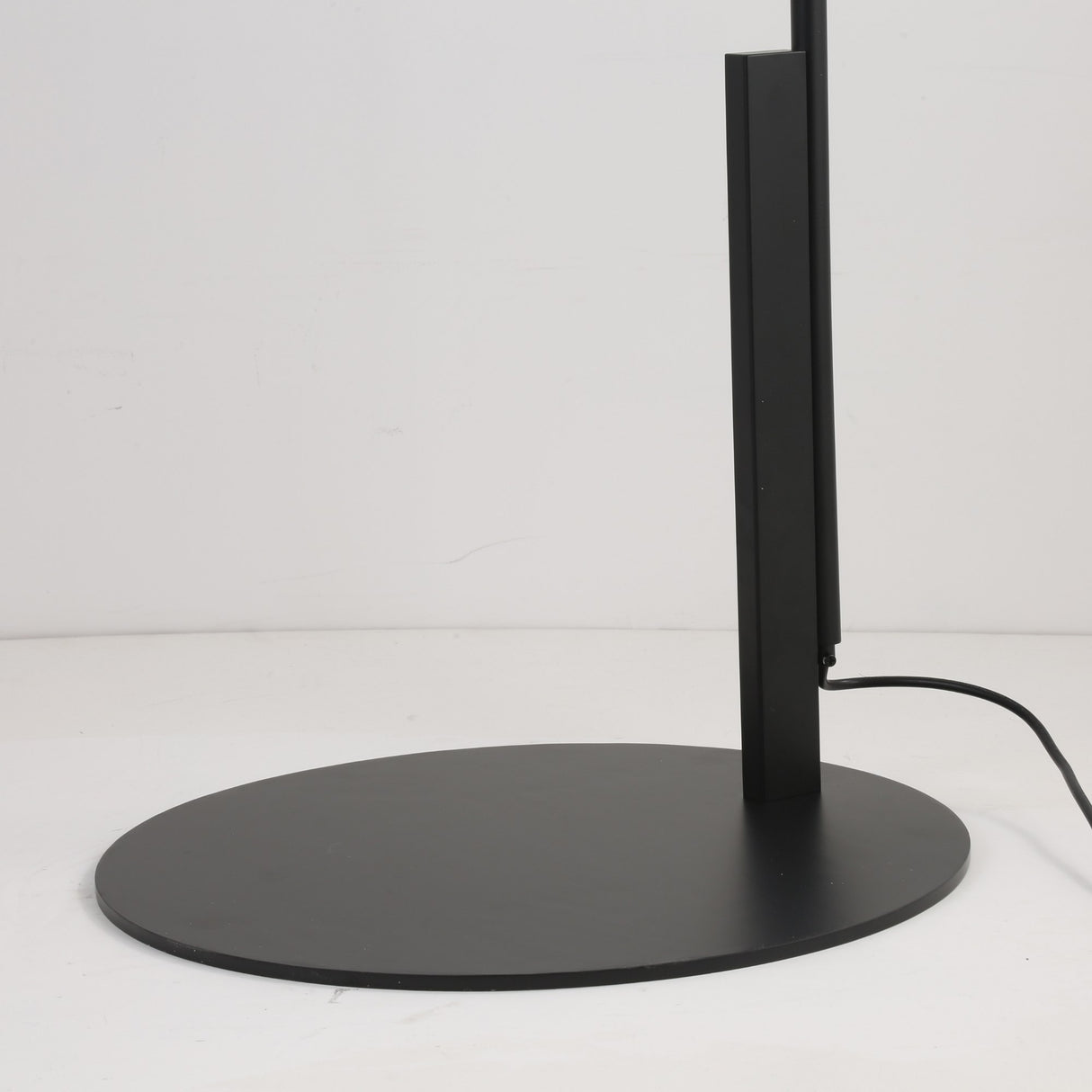 A close-up side view of the Ginger LED Large Floor Lamp in black & brown, featuring a slim, vertical design on a round black base with visible power cord, shown against a plain white background.