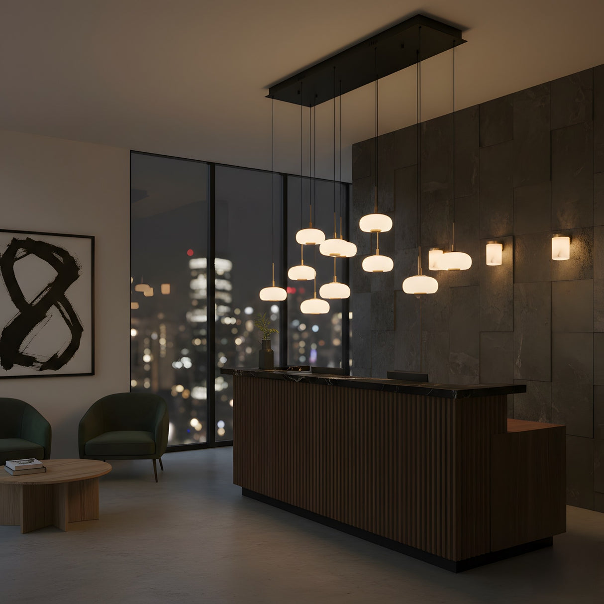 Niori Aurevia 14 Light LED linear chandelier in matt black and brass with staggered alabaster domes above a wood reception desk by a city-view window.