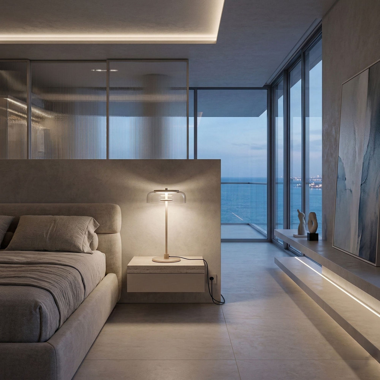 A modern minimalist bedroom with a large bed, the Blossom LED Glass Table Lamp - Gold glowing on the side table, floor-to-ceiling windows revealing a sea view at dusk, abstract wall art, neutral tones, and sleek design.