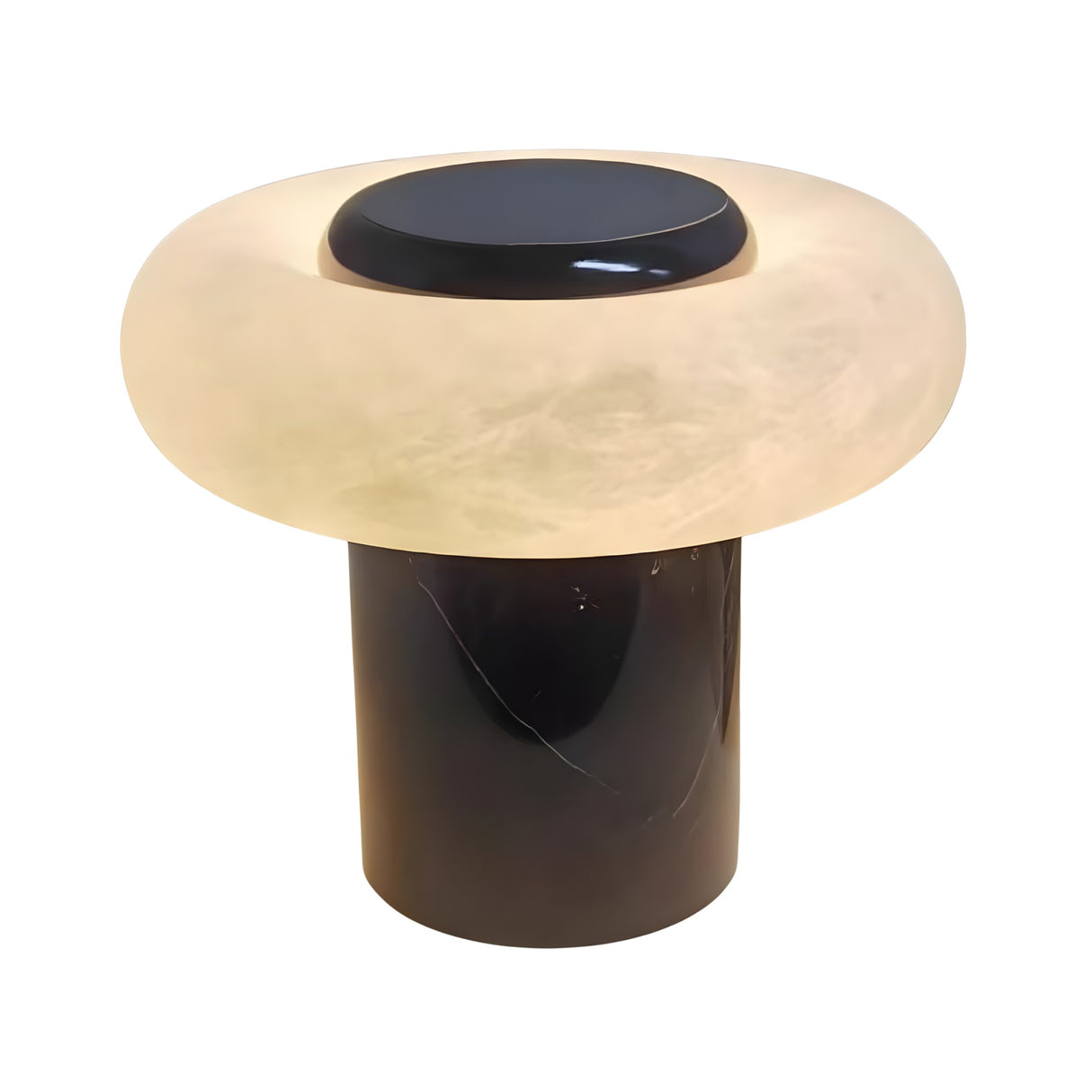 The Orvixa LED Rounded Alabaster Disc Table Lamp features a sculptural design with a cylindrical black base and a wide, soft white translucent shade that glows gently.