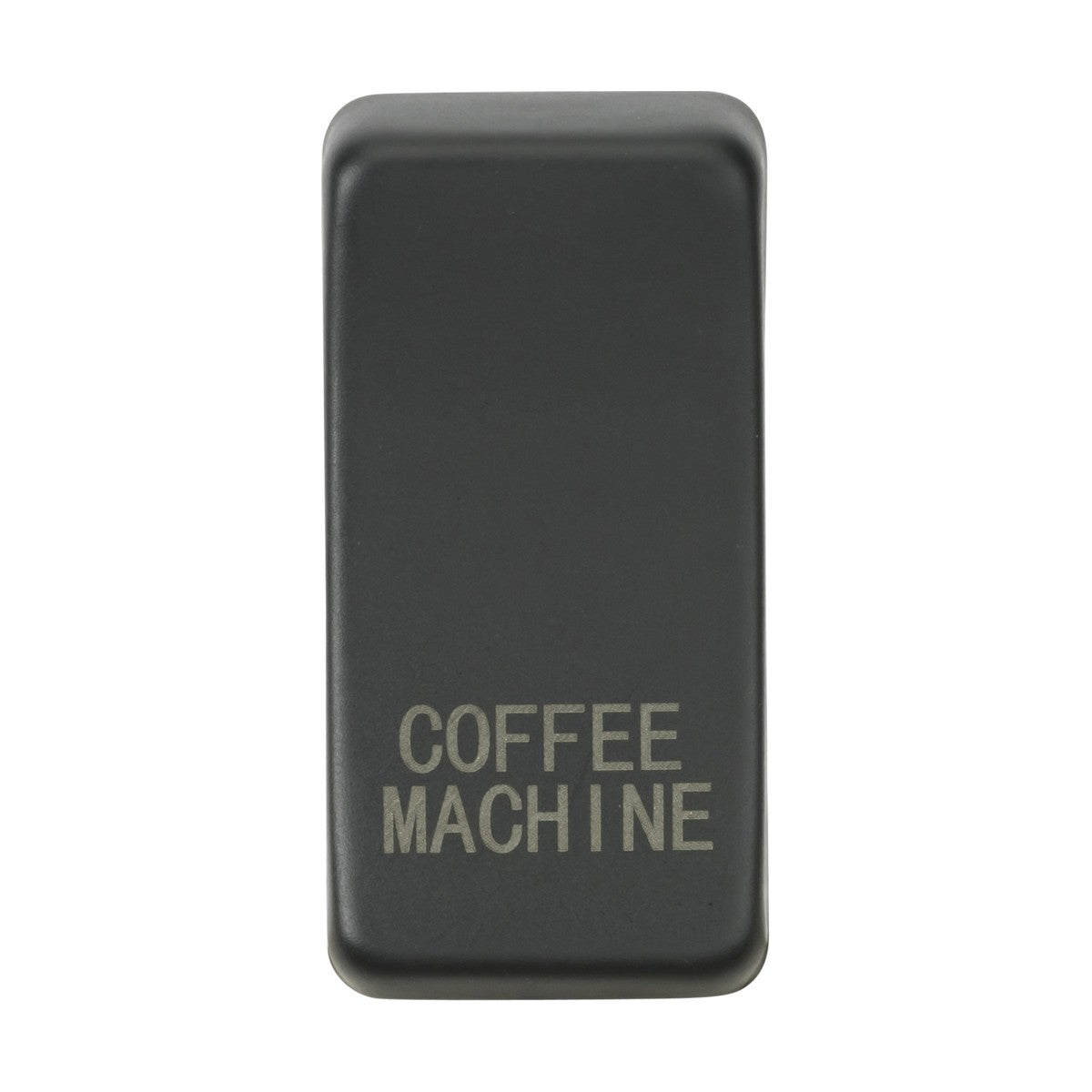 An anthracite switch cover with the words "COFFEE MACHINE" engraved on it, positioned against a plain white background.