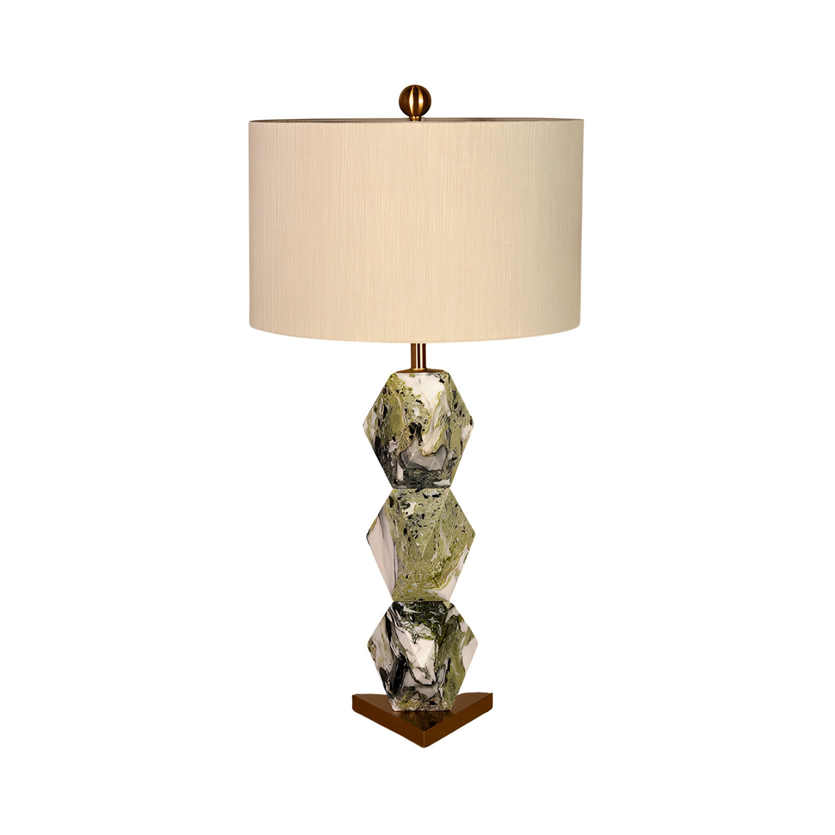 The Zerava 1 Light Faceted Marble Table Lamp in black and green has a geometric base of three stacked marbled hexagons and a gold triangular stand, topped with a beige cylindrical shade for striking sculptural style.